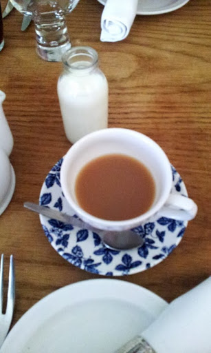 Tea with tiny milk bottle